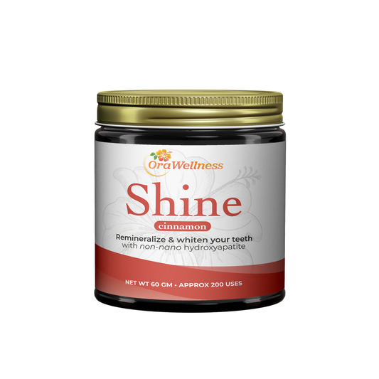 Jar of OraWellness Shine teeth powder with cinnamon flavor on a white background