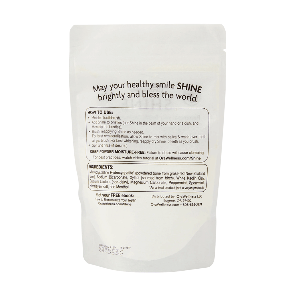 Packaging of Shine Remineralizing Tooth Whitening Powder, with product information and branding visible.